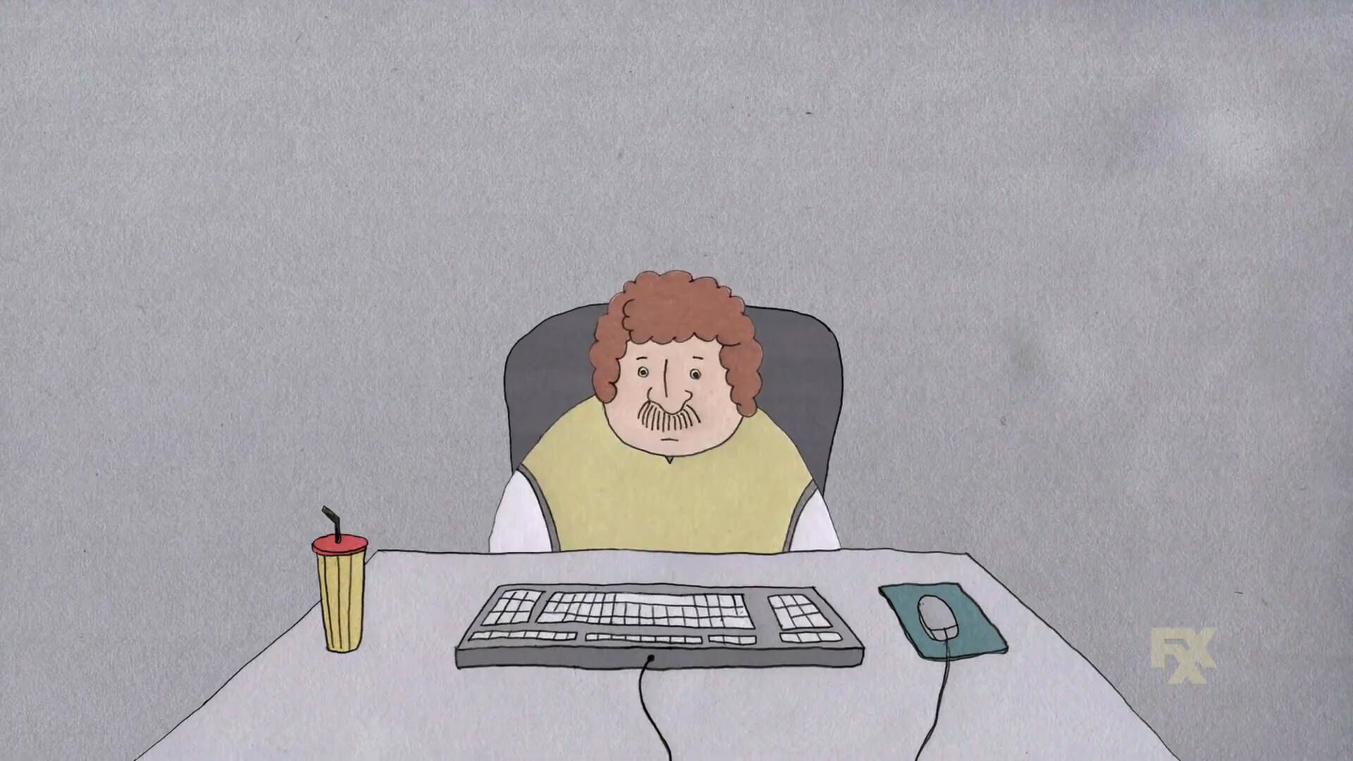 A somber man sits alone at a computer keyboard in a short animation from FXX's CAKE