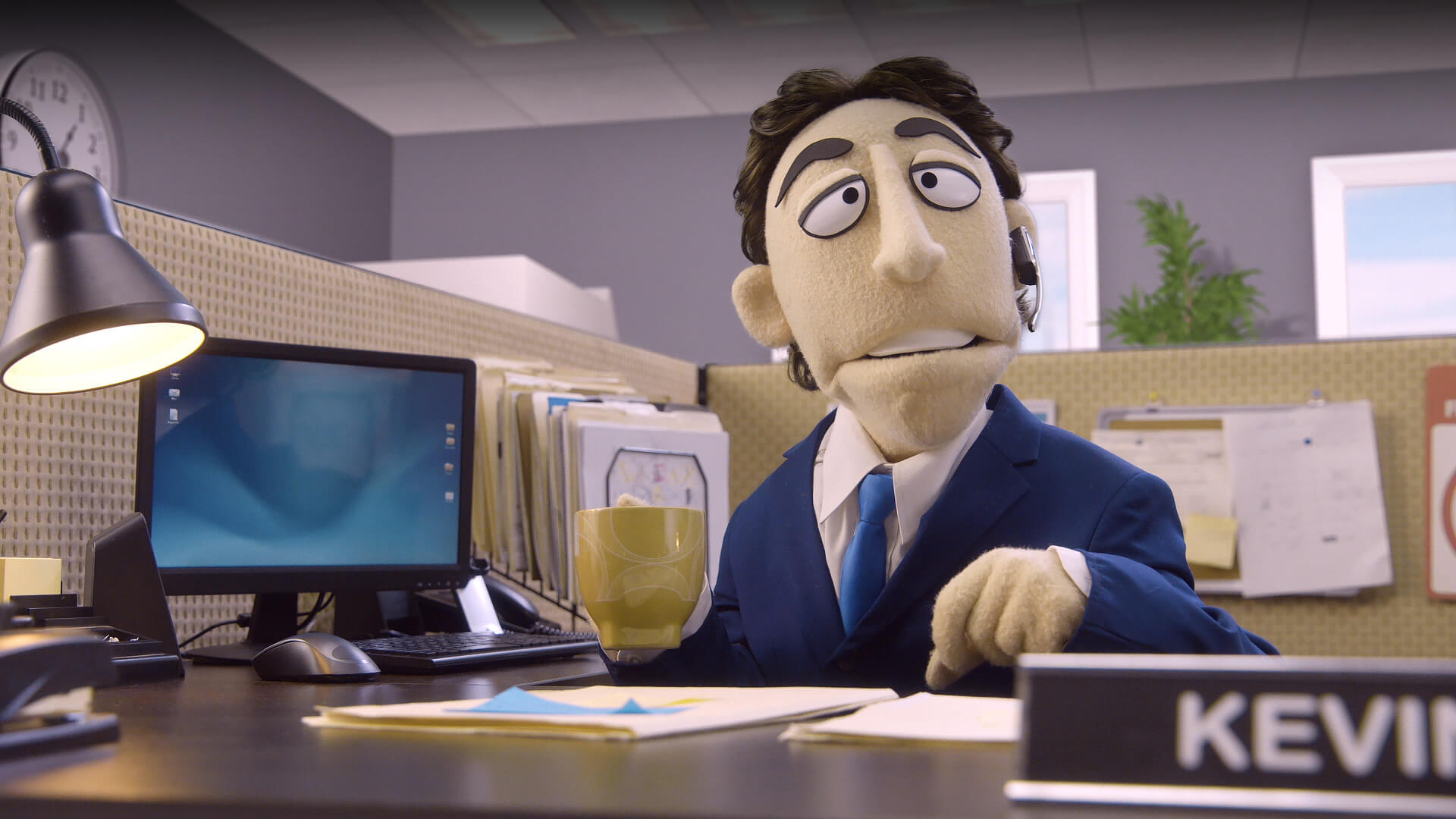 A muppet-styled puppet of Kevin Nealon at his office desk on Comedy Central's Crank Yankers